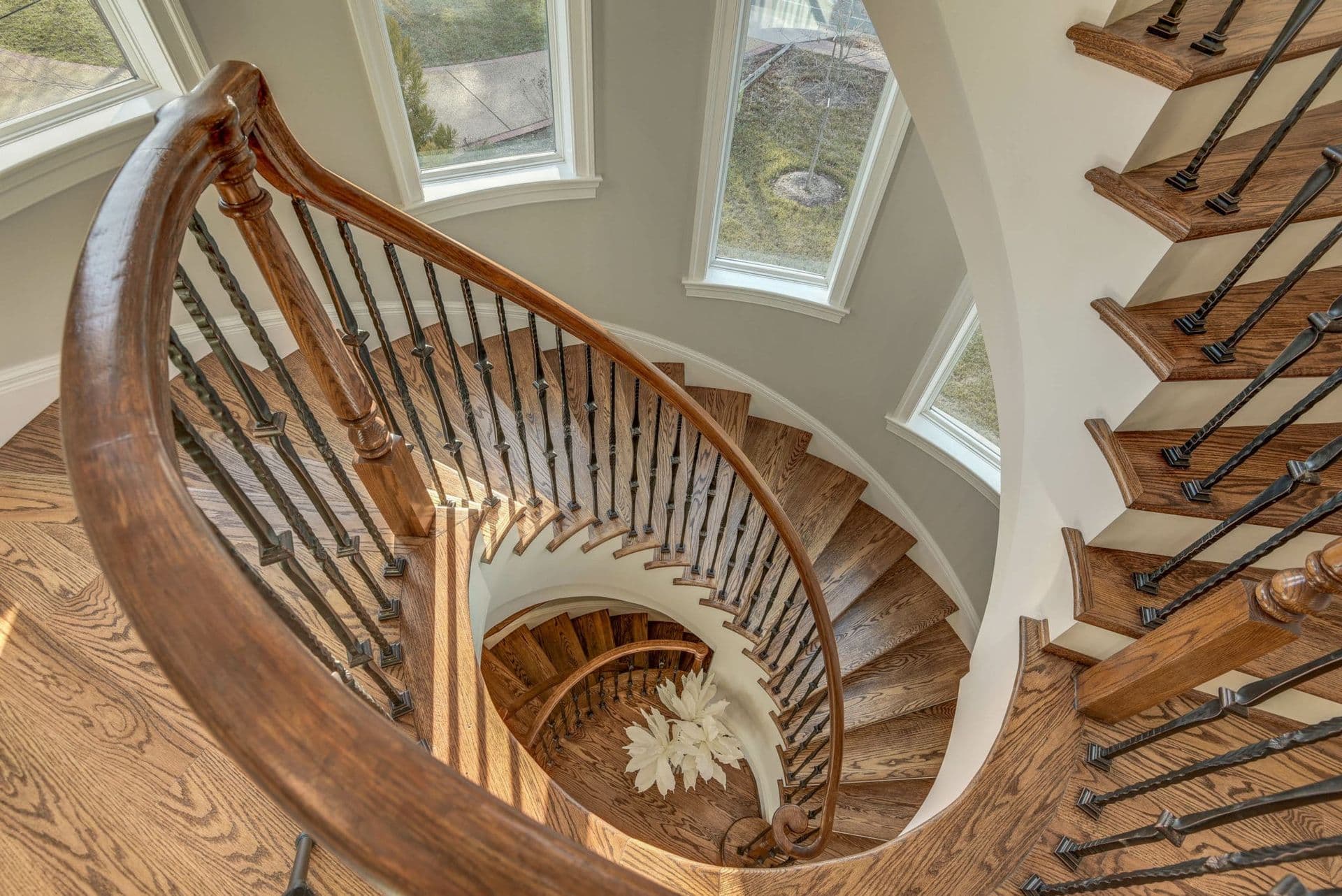 Homeowners are installing hardwood floor on curved stairs